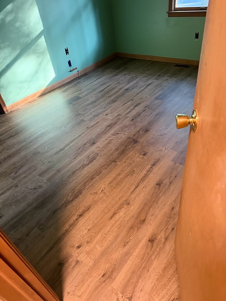 Ewing, NJ: Corner bedroom, brown oak plank laid the long way, an RJ Laminates installation