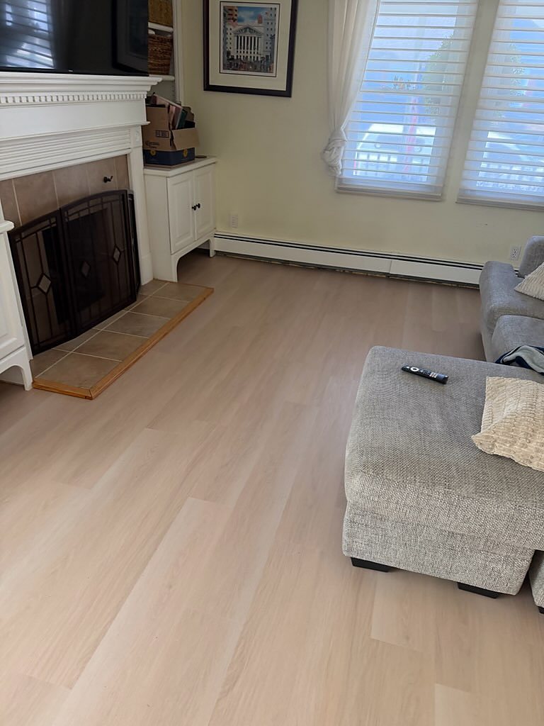 Yardley, PA: Living room, pale oak plank laid past the hearth, an RJ Laminates installation